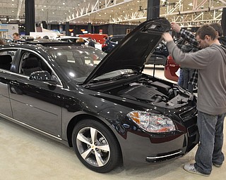Inspecting a Chevrolet Malibu at the 2009 Cleveland Auto Show