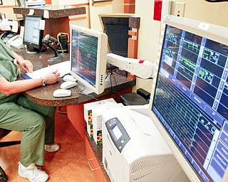 Jerri Nastase, a unit secretary at Mahoning Valley Hospital in Boardman at work near telemetry monitors in the hospital. 
