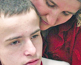 Debbie Maust of Canfield shares a moment with her son Collin, 14, who is a student at The Rich Center for Autism in Youngstown.