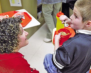 Debbie Maust of Canfield shares a moment with her son Joshua, 10, who is a student at The Rich Center for Autism in Youngstown. 