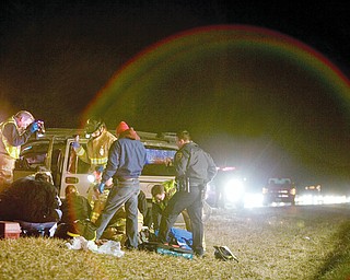 Emergency workers tend to one of three seriously injured people involved in an accident along Route 11 one-and-a-half miles north of the 224 exit Wednesday night. According to the State Highway Patrol, four individuals were riding in a van when the driver lost control of the vehicle and three passengers were ejected from the vehicle.