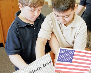 Lowellville 3rd graders Kyle Baird, left, and Nick Kacir prepare for World Math Day event at their school Wednesday.