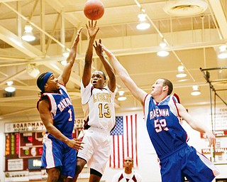 Ravenna's Blayre Davis (1) and D.J. Paulat (52) try to stop Liberty Anthony Cleveland (13) from scoring at Boardman High School, Wednesday March 4, 2009