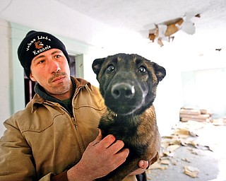 MAN'S BEST FRIEND: Dog trainer Dave Blosser gives Storm, an 11-month-old Belgian malinois, some personal attention. Storm is one of the dogs Blosser is training for police work.