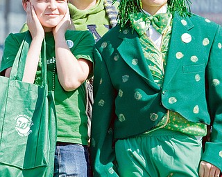 Jeremy Brown, 12, mother Maryann Brown, both of Homeworth, and friend, Parker Zamarelli, of Salem stand along Market Street during the 31st annual Mahoning Valley St. Patrick's Day Parade. "Its really cool," said Zamarelli who  said he hadn't been the the parade since he was much younger as he dawned an frog costume recently worn in a school production.