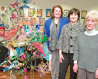 Art Instructor, Mary Beth Wensel, Supervisor, Michele Krisher, and Art Instructor, Kathy Young, stand along a sculpture made by students from Trumbull Co. Educational Service Center Arts Excel in the Arts Outreach Center at Eastwood on Sunday afternoon.