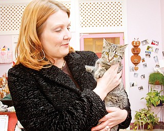 Marty Kish of New Middletown with her newly adopted cat at the Cat Ladies Society Rescue and Adoption, Thursday March 12, 2009