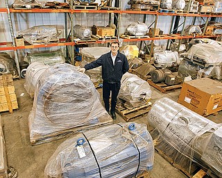 CMT Mike Kovach is standing in the  warehouse where finished rebuilt machines are ready for shipment. when the economy picks up
