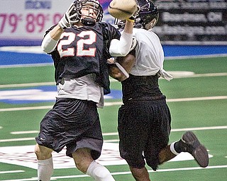 Chris Schubert (22) makes a catch against Clarence Curry during The Mahoning Valley Thunder practice at the Chevey Centre on Tuesday March 25, 2009.