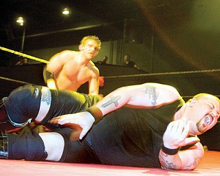John Cathelin known as "The Bouncer," of Broadview Heights, writhes in pain on the mat while wrestling Nicky Valentino known as "The Pinnacle" during a match at The Wedge Nightclub in Autintown, on Friday evening. Catheline, who has been wrestling for 13 years, won the fight against Valentino who has just been wrestling for a couple months. "Ever since I was four years old, this was the only thing i wanted to do," said Catheline.