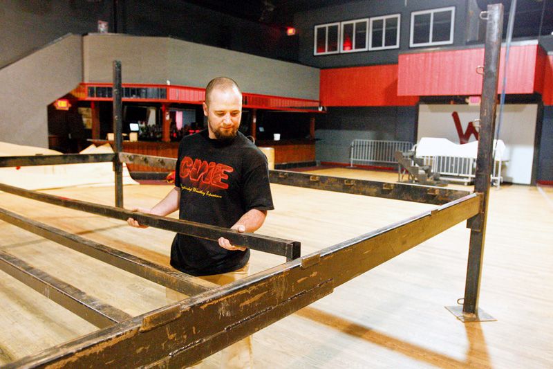 Kyle Terreri assembles the steel frame  for the wrestling ring at the Wedge in Austintown