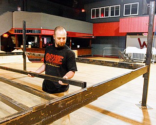 Kyle Terreri assembles the steel frame for the wrestling ring at the Wedge in Austintown