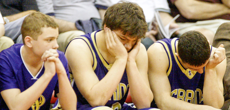 Sebring players, Jesse James, Joe George and Anthony Corbett sit quietly as their state title bid was ended by Marion Local in the semi finals. Sebring lost 52-45. 