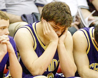 Sebring players, Jesse James, Joe George and Anthony Corbett sit quietly as their state title bid was ended by Marion Local in the semi finals. Sebring lost 52-45.