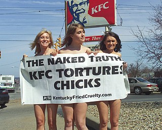 BARING IT ALL:  From left to right; Ashley Byrne, 31, of Washington D.C., Cassandra Callaghan, 20, of Norfolk, Va., and Michelle Lackner, 21, of Rochester, Pa., pose outside the South Avenue KFC restaurant wearing nothing but stilettos, smiles and a banner. The women participated in a protest for the animal-rights activist group PETA, People for the Ethical Treatment of Animals, by standing outside the restaurant for an hour to raise awareness on KFC supplier’s methods for housing and slaughtering chickens. PETA has traveled to KFC restaurants around the country as part of their “Naked Truth” campaign.