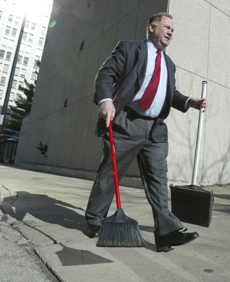 Scott Burin, owner of the International Towers building in downtown Youngstown, Oh. goes through his daily ritual of picking up litter from his property.