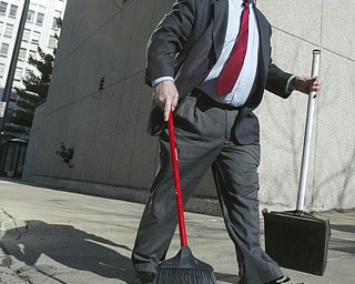 Scott Burin, owner of the International Towers building in downtown Youngstown, Oh. goes through his daily ritual of picking up litter from his property.
