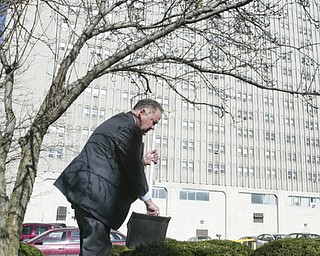 Scott Burin, owner of the International Towers building in downtown Youngstown, Oh. goes through his daily ritual of picking up litter from his property.