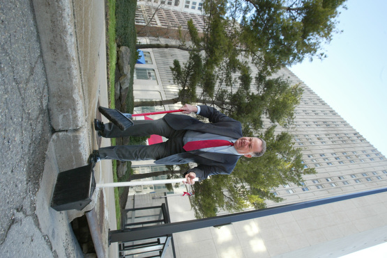 Scott Burin, owner of the International Towers building in downtown Youngstown, Oh. goes through his daily ritual of picking up litter from his property.