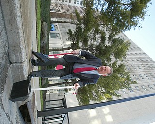 Scott Burin, owner of the International Towers building in downtown Youngstown, Oh. goes through his daily ritual of picking up litter from his property.