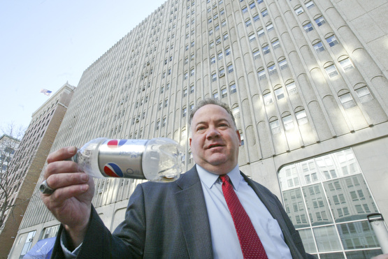Scott Burin, owner of the International Towers building in downtown Youngstown, Oh. goes through his daily ritual of picking up litter from his property.
