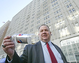 Scott Burin, owner of the International Towers building in downtown Youngstown, Oh. goes through his daily ritual of picking up litter from his property.