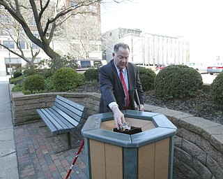 Scott Burin, owner of the International Towers building in downtown Youngstown, Oh. goes through his daily ritual of picking up litter from his property.