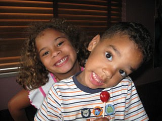 The Walkowiec siblings, DELIA, 8, and ZENIN, 4, of Boardman, share their gap-tooth grins for the camera.