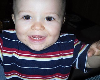 JAMES ARTHUR WHITE IV, 10 months old, of Fort Hood, Texas, shows his grandma, Rosemarie White of New Bedford, Pa., his toothless grin during a recent visit.