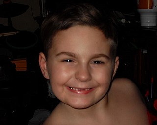 JOEY NAPLES, 7, of Youngstown shares his toothless grin.