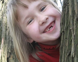MADISON HORNIKEL of Girard smiles for her grandmother, Vera Orosz of Canfield, at near St. James Meeting House in Boardman Township Park.