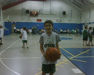 KRIS SCANDY of Austintown poses for his fans at a basketball game. The photo was sent by Kris’ nana, Connie Scandy.