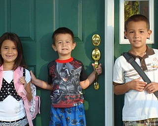 LUCIA ROHRBAUGH, left, is shown on her first day of first grade at C.H. Campbell School in Canfield — minus her two front teeth. Pictured with her are her brothers, Luigi and Lorenzo. The picture taken by their grandmother, Paula D’Apolito.