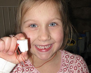 MADDIE WILLS, 6, lost her first tooth and shows off her “tooth box.” She is the daughter of Chris and Staci Wills of Canfield.