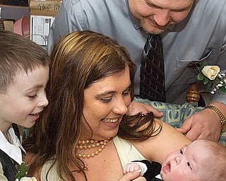 HAPPY AND HEALTHY: Melissa Kascask, 28, holds 7-month-old son Hunter, while her son Christian Grubb, 7, left, and husband Chadd Kascsak, 23, look on. Chadd and Melissa were married at Akron Children’s Hospital Tuesday morning, where Hunter, born four months premature, has been since December. The couple said they’d rather get married at Hunter’s bedside than wait and have a large ceremony.