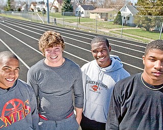 Sprinters on the Cardinal Mooney Track Team, Charlie Brown (sophmore), Scott Johnson (senior), Matt McWilson (senior), Braylon Heard (junior) pose for a portrait at Cardinal Mooney Track on Wednesday April 8, 2009.