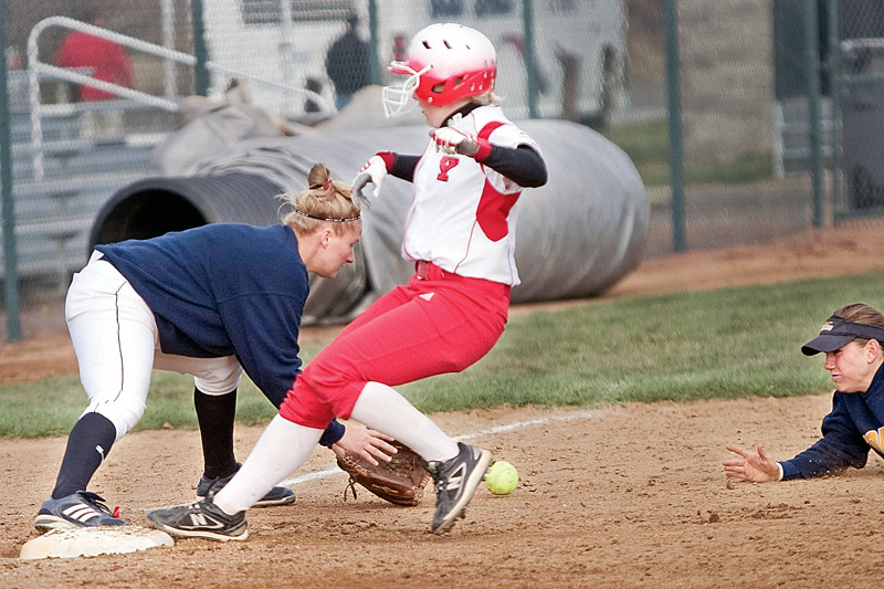 YSU's Haley Thomas arrives safely at third base ahead of Toledo shortstop/second baseman Brie Ford's toss to teamate Kelly Hmiel during the bottom of the third inning of the second game of a double header at McCune Park Wednesday evening. The women Penguins won both games of the double header defeating the Rockets 12-4 in game one and 11-2 in game two.