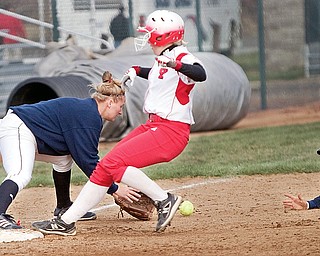 YSU's Haley Thomas arrives safely at third base ahead of Toledo shortstop/second baseman Brie Ford's toss to teamate Kelly Hmiel during the bottom of the third inning of the second game of a double header at McCune Park Wednesday evening. The women Penguins won both games of the double header defeating the Rockets 12-4 in game one and 11-2 in game two.