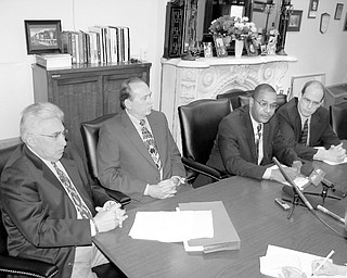 From left, Atty. Danny Thomas of Warren, Law Director Greg Hicks, Safety Service Director Doug Franklin and Mayor Michael O'Brien discuss the agreement with the city John Mandopoulos signed with the city on Wednesday. Mandopoulos, chief since December 2000, agreed to step down immediately and remain on sick leave until Aug. 10, when his retirement begins. Mandopoulos is 61 years old.
