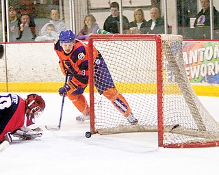 Mahoning Valley Phantom Robert Harrison (4) puts the puck past Traverse City North Stars C.J. Motte (30) during the second period scoring the teams second goal at The Ice Zone Sunday evening.