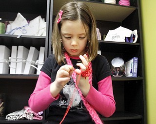 Cortney Prout (7) of Canfield demonstrates finger knitting at Design It in Canfield,