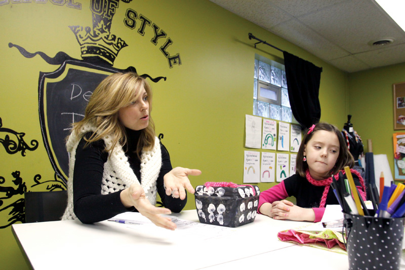 Design It owner Jenifer Daigle (34) of Canfield and Cortney Prout (7) of Canfield talks about finger knitting and Design It in Canfield