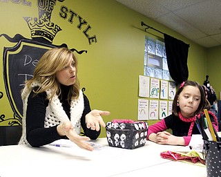 Design It owner Jenifer Daigle (34) of Canfield and Cortney Prout (7) of Canfield talks about finger knitting and Design It in Canfield