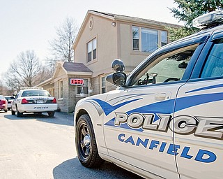 Canfield Police officers serve a warrant at the El Patio Motel in Canfield in order to search the premises for evidence of prostitution on Thursday afternoon.