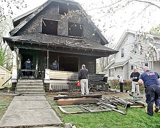 City of Warren Fire investigators and investigators for the state fire marshal remove items as they investigate a early morning blaze that injured a Warren Policeman and three residents. State Fire Marshal investigators have ruled arson as the cause of this morning’s fire at a group home on Bonnie Brae Avenue.