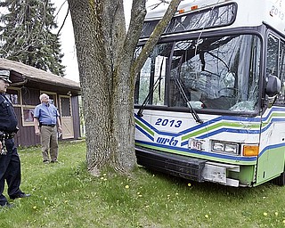 YPD Traffic Officer Jimmy Rounds, left, and Don Meszaros, WRTA director of Maintenance survey damage to a WRTA bus involved in a collision Tuesday afternoon on McCartney Rd and Rutledge in Youngstown. 