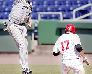 YSU's Jeremy Banks heads to first as Milwaukee 1 rst baseman Dan Buchloz tries to make the catch during 4 th inning at Eastwood Field. Banks was called safe. 