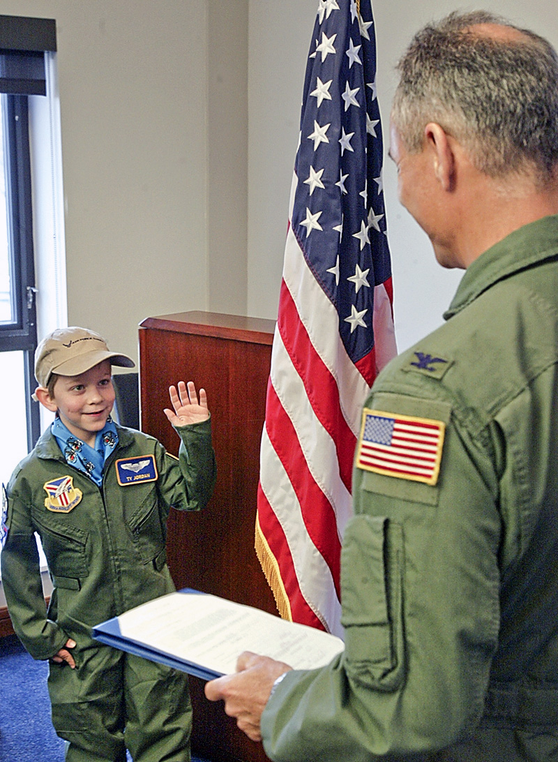 Youngstown Warren Air Force Reserve Station base Commander Col Karl McGregor swears in Tyler Jordan, 8, of Niles as an officer for Pilot for a Day program.