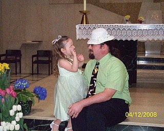 EMMA GARON, 3, of Hubbard thought her Easter bonnet looked better on her daddy, Adam.
