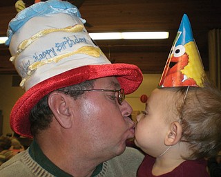 JIM DORMAN of Boardman shares a kiss with his grandson, Peter Koulianos of Campbell, on their joint birthday. Nov. 11.
